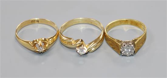 Two 18ct gold and solitaire diamond rings and a 14k and solitaire diamond ring.